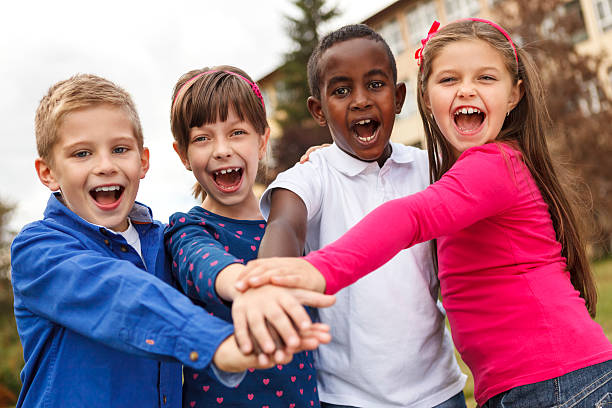 istock School children shouting with their hands joined together 456101365