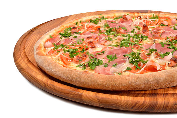 istock Pizza with ham tomato and onion on a wooden platter 456102585