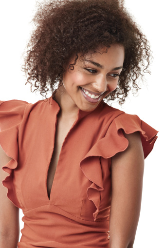 Cute young african american woman looking away shyly and smiling