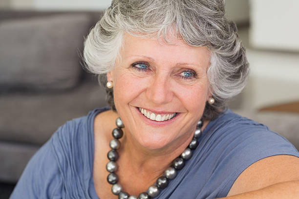 istock Happy mature woman sitting on sofa 456106195
