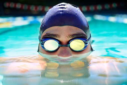 Cropped view of a determined male swimmer swimming laps