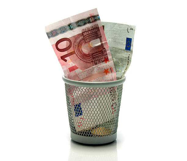 istock money in a trash 456111567