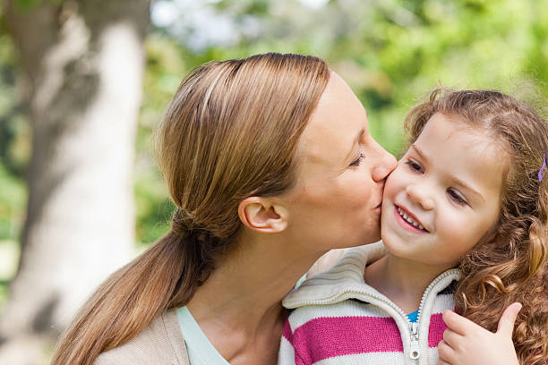 istock Mother giving her child a kiss 456117665