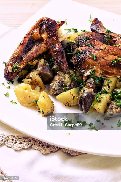 Roast Chicken With Potatoes And Artichokes Stock Photo - Download Image Now - Animal Body Part, Animal Leg, Animal Limb