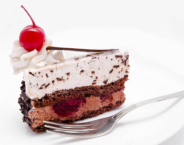 istock Slice of chocolate cake with cherry on the top isolated 456118683