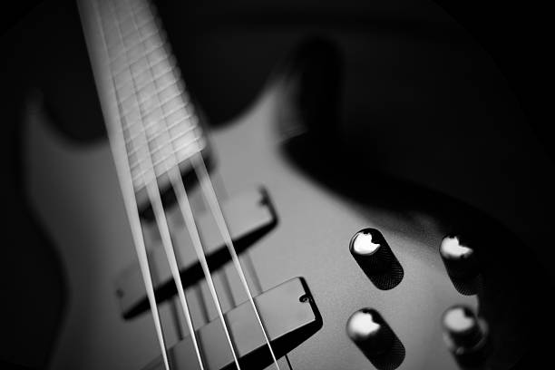 Bass Guitar Bass Guitar with narrow depth of field bass guitar stock pictures, royalty-free photos & images