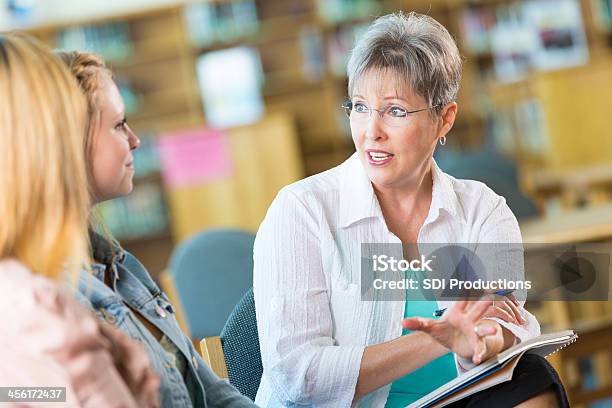 Senior Teacher Or Principle Meeting With Student And Parent Stock Photo - Download Image Now