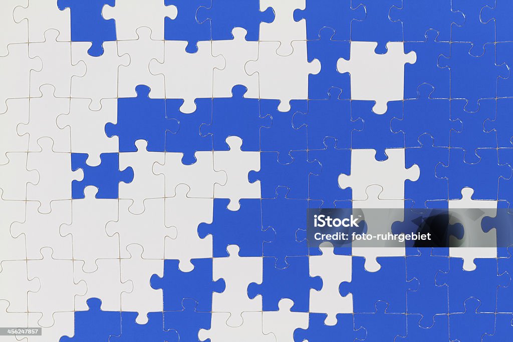 Puzzle A puzzle is made up of puzzle pieces in two colors. Heap Stock Photo