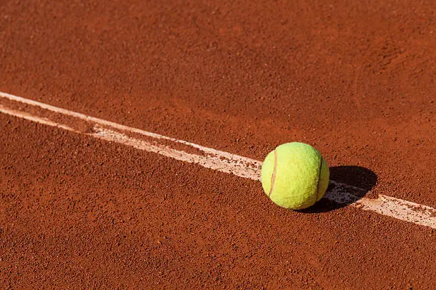 CLose-up photograph of tennis ball on the court