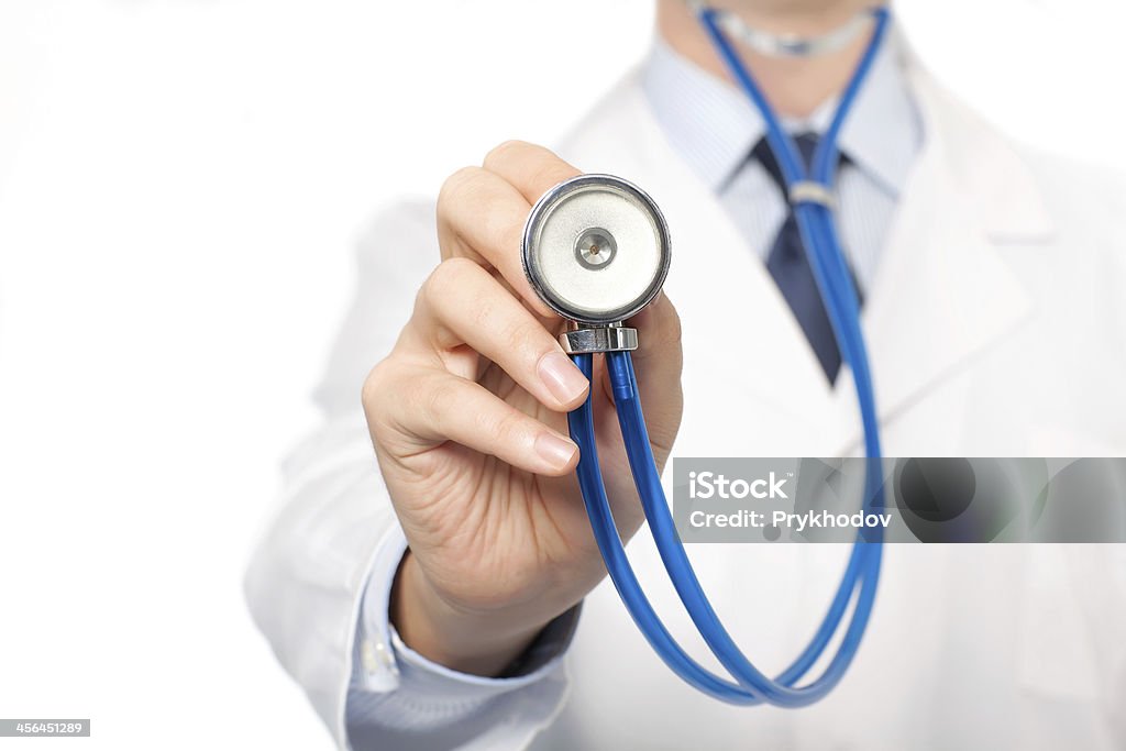 doctor in a white lab coat holding stethoscope The doctor in a white lab coat holding a stethoscope Adult Stock Photo
