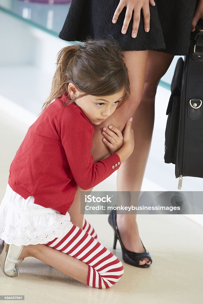 Daughter Clinging To Mother's Leg Daughter Clinging To Working Mother's Leg Mother Stock Photo