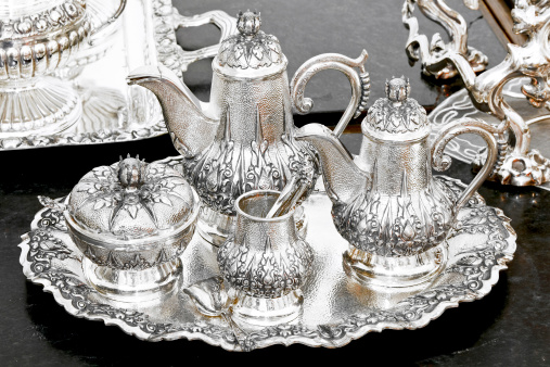 Old luxurious silver tea set at tray.