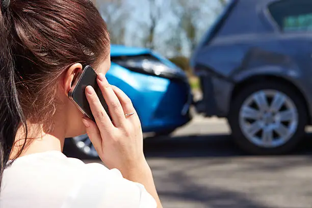 Photo of Female Driver Making Phone Call After Traffic Accident