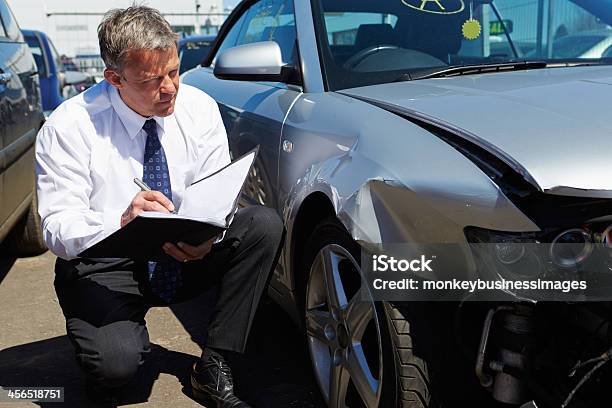 Loss Adjuster Inspecting Car Involved In Accident Stock Photo - Download Image Now - Car, Insurance, Crash