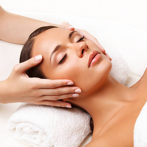 Face Massage.  Close-up of a Young Woman Getting Spa Treatment. stock photo