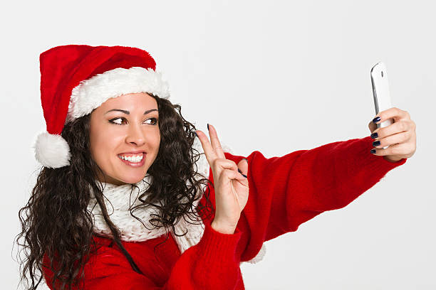 istock Attractive brunette santa girl taking self portrait 456532709