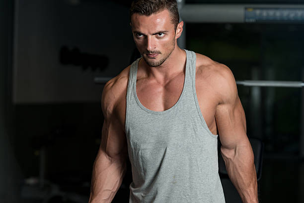 istock Muscular Man Exercising Biceps In Gym 456533719