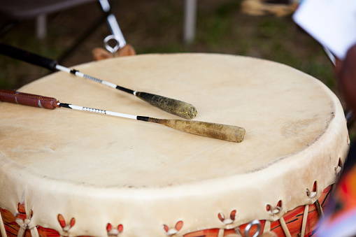 Indian drum and drum sticks placed in a symbolic manner after the drummers complete their song at a Native American pow-wow.