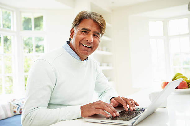 istock Senior Indian Man Using Laptop At Home 456539603