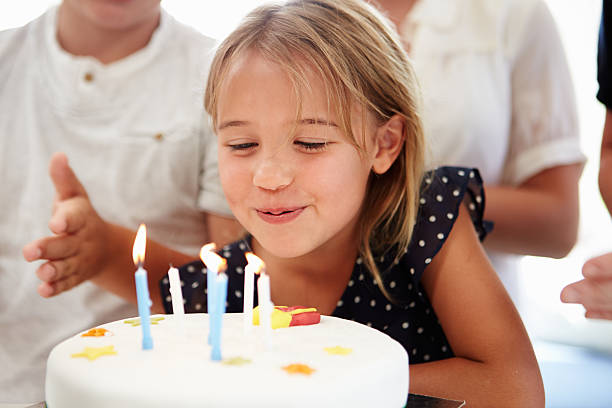 少女のバースデーケーキ - cake birthday candle blowing ストックフォトと画像