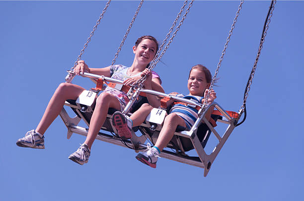 istock Girls having fun on a carnival swing 456549835