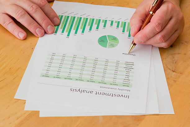 istock senior businessman analyzing green charts with pen 456571151