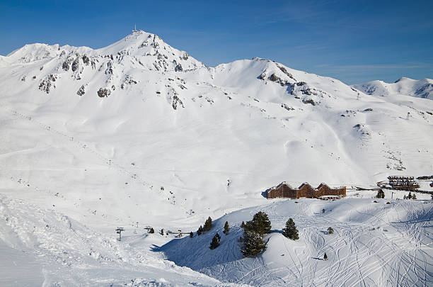 Ski resort in the winter Pyrenees There are downhills, aerial lifts, skiers and hotels on the snow slopes in the winter Pyrenees. leisure activity french culture sport high angle view stock pictures, royalty-free photos & images