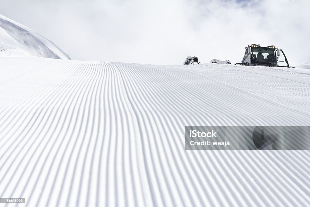 Fresh snow groomer tracks on a ski piste Activity Stock Photo