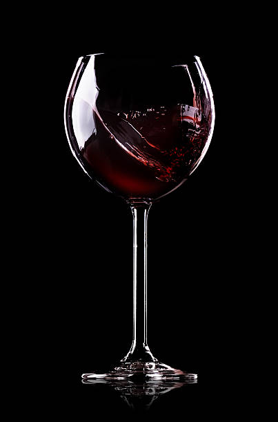 istock Wave of wine in wineglass 456618597