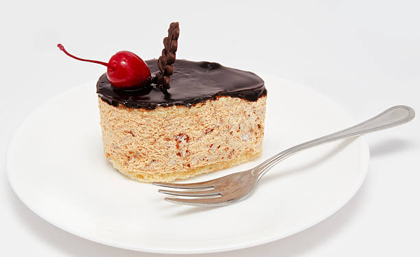 istock Cake icing with cherry on the plate isolated 456626785