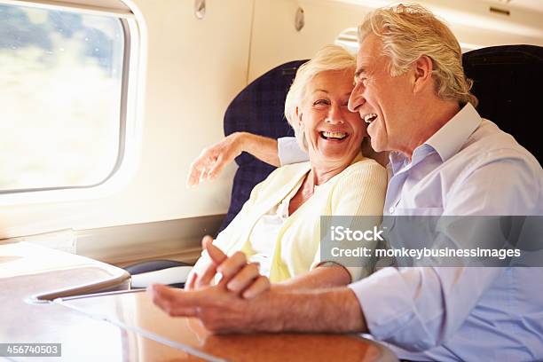 Senior Couple Relaxing On Train Journey Stock Photo - Download Image Now - Train - Vehicle, Senior Adult, Travel