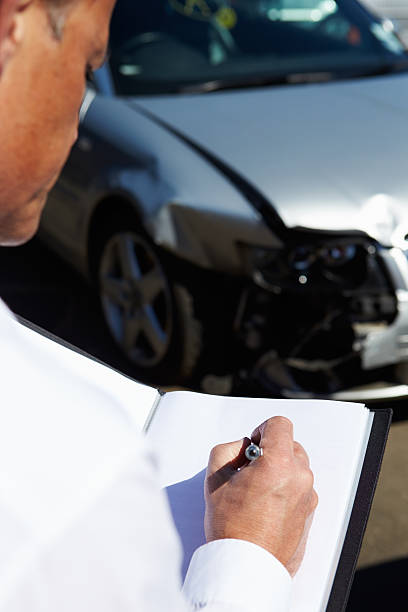 istock Loss Adjuster Inspecting Car Involved In Accident 456741381
