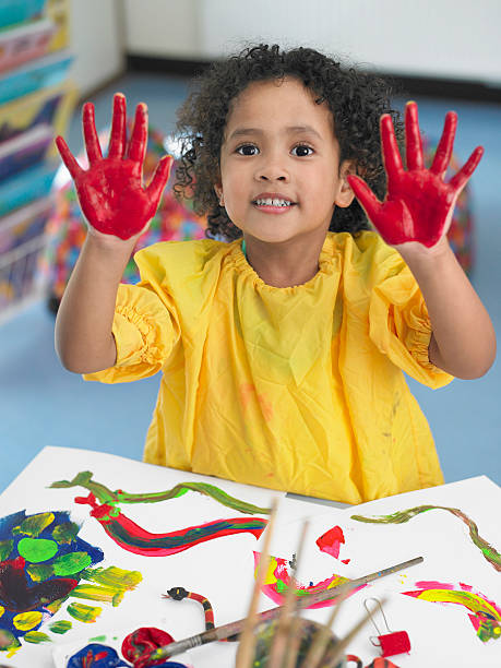 istock Girl Finger Painting In Art Class 456748665
