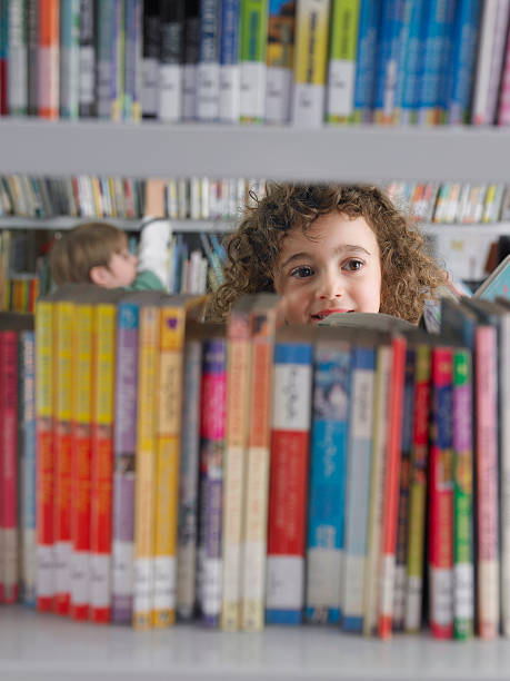 istock Girl Selecting Books From Library Bookshelf 456748779