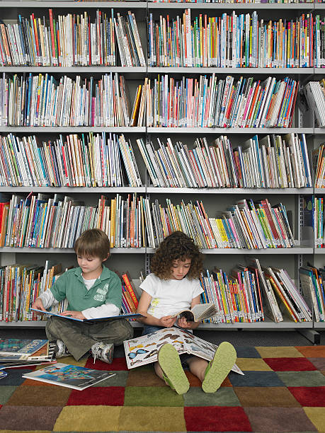 istock Young boy and girl reading in a library 456748847