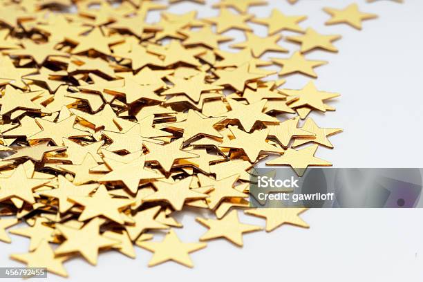 Christmas Decoration Of Golden Confetti Stars Against White Background Stock Photo - Download Image Now