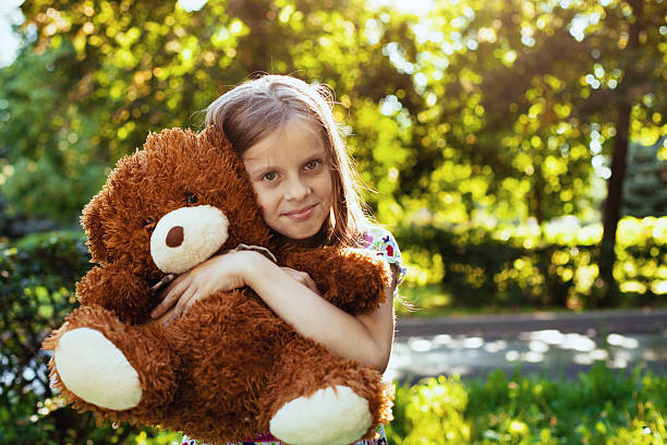 istock little girl with teddy bear 456796091