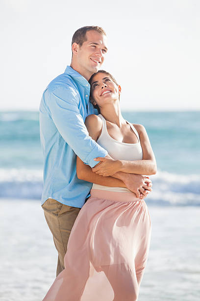 istock Happy couple holding each other at the beach 456854689