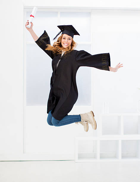 istock Young Cheerful College Female Graduate Jumping. 456855221