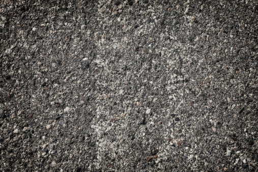 Ground texture - close-up of a fragment of compact and stony ground - rocky stony ground background