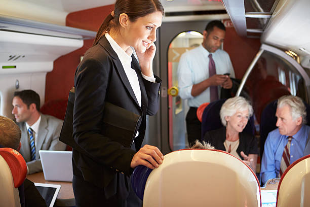 istock Businesswoman Using Mobile Phone On Busy Commuter Train 456861617