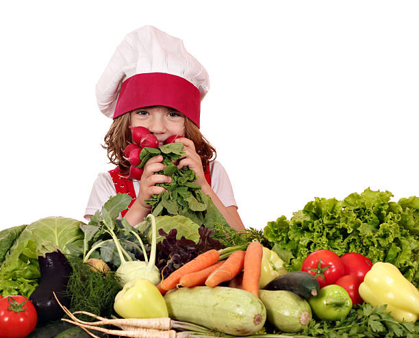 istock beautiful little girl cook with different vegetables 456862357
