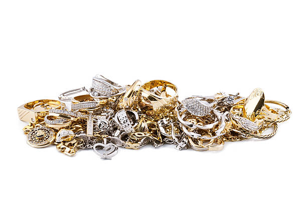istock Pile of assorted silver and gold jewelry on white backing 456899293