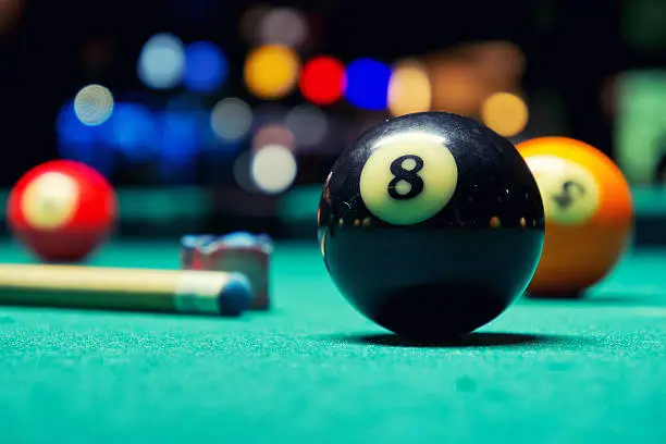 A Vintage style photo from a billiard balls in a pool table. Noise added for a film effect
