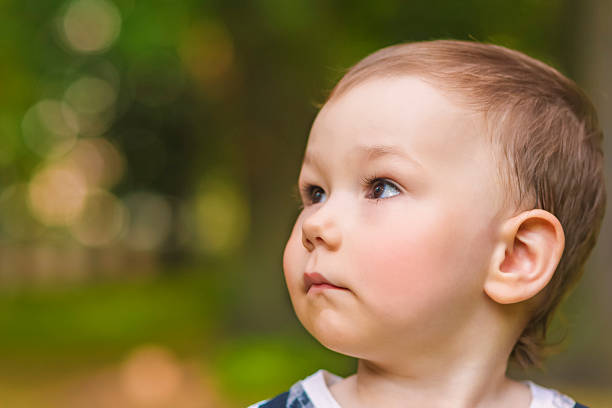 istock Profile of a Little Cute Boy Outside 457026153