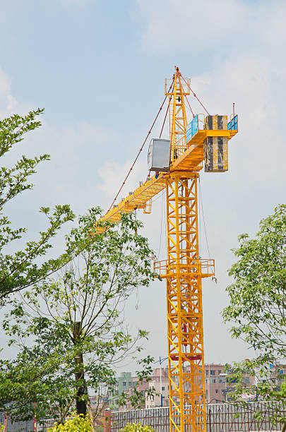 istock Yellow construction crane isolated on clear blue sky. 457039567