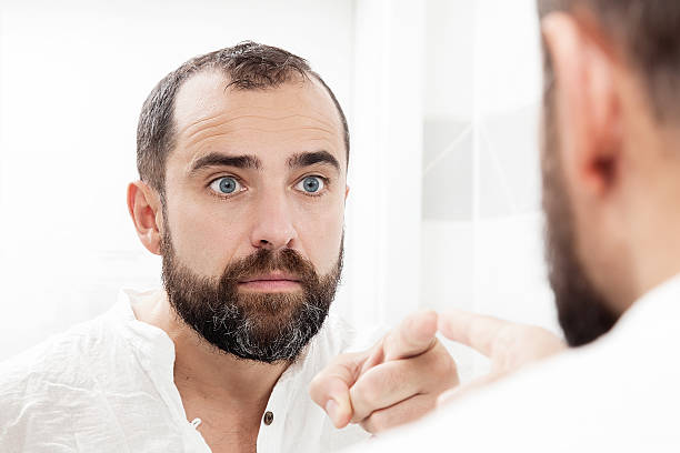 istock Man looking at himself in the mirror and pointing 457039869