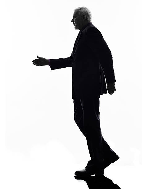 istock senior business man walking handshake silhouette 457042587