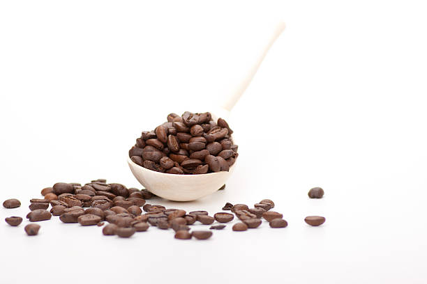 istock wooden spoon with coffee beans, isolated 457043513