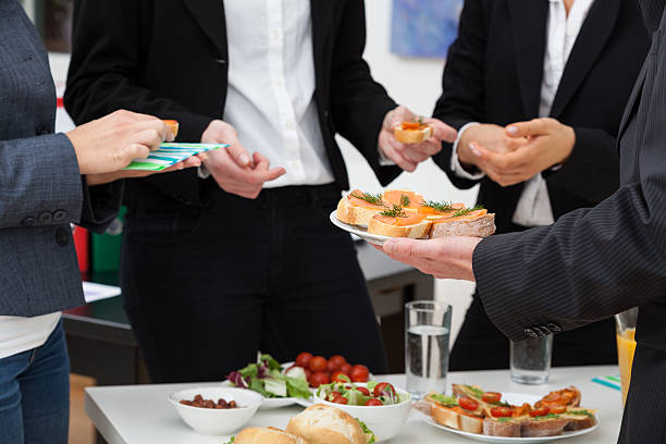 Managers meeting on breakfast Managers meeting with healthy food in office tail coat photos stock pictures, royalty-free photos & images